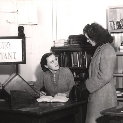 Type : Photograph Medium : Print-black-and-white Description : A view of the temporary Lending Library Central Library New Bridge Street Newcastle upon Tyne taken in 1949.  The photograph shows the Inquiry desk where an assistant is dealing with a query from a member of the public.Libraries Collection : Local Studies Source of Information : The photograph was taken when alterations were being made to the library. Printed Copy : If you would like a printed copy of this image please contact Newcastle Libraries www.newcastle.gov.uk/tlt quoting Accession Number : 048844